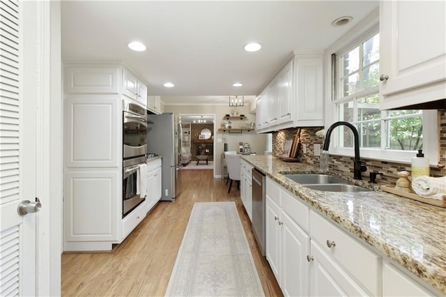 3719 Northbrook Ct, Atlanta, GA 30340 - kitchen with a sink, light wood-type flooring, white cabinetry, tasteful backsplash, and stainless steel appliances