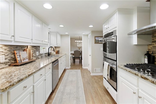 3719 Northbrook Ct, Atlanta, GA 30340 - kitchen with a sink, wall chimney exhaust hood, stainless steel appliances, light wood-type flooring, and decorative backsplash