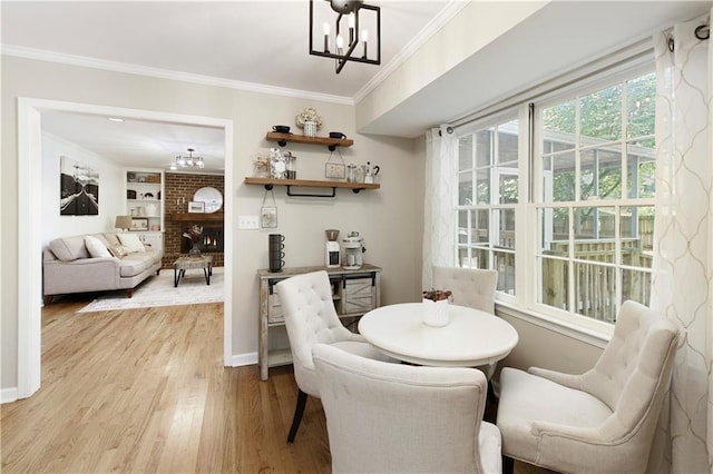 3719 Northbrook Ct, Atlanta, GA 30340 - dining space featuring a chandelier, wood finished floors, a brick fireplace, crown molding, and baseboards