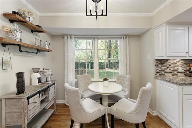 3719 Northbrook Ct, Atlanta, GA 30340 - dining space featuring light wood-type flooring, ornamental molding, a chandelier, and baseboards