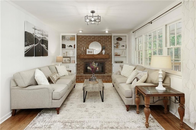 3719 Northbrook Ct, Atlanta, GA 30340 - living room with wood finished floors, built in shelves, ornamental molding, and a fireplace