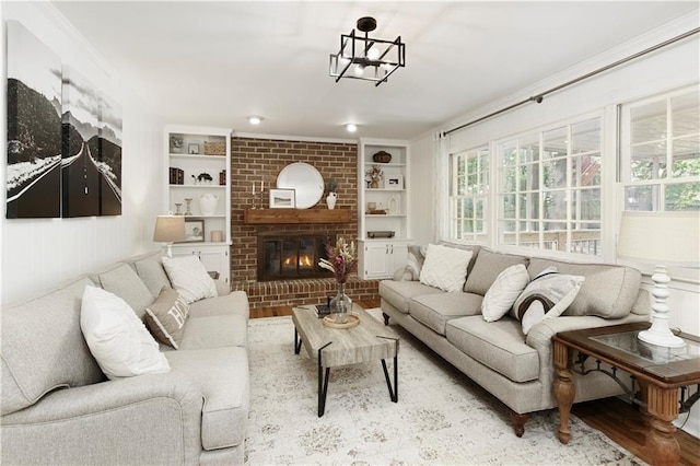 3719 Northbrook Ct, Atlanta, GA 30340 - living area with built in shelves, healthy amount of natural light, wood finished floors, a brick fireplace, and crown molding