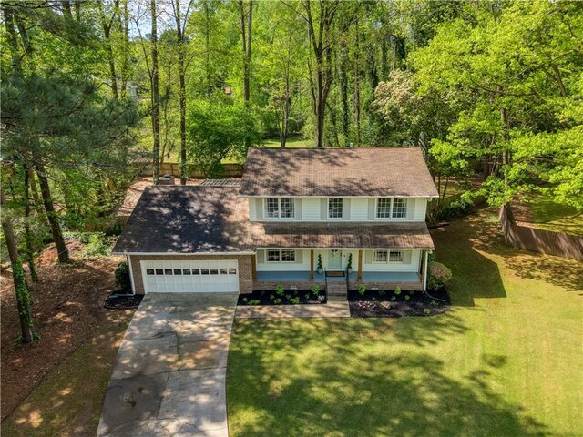 3719 Northbrook Ct, Atlanta, GA 30340 - traditional-style house featuring a porch, concrete driveway, an attached garage, and a view of trees