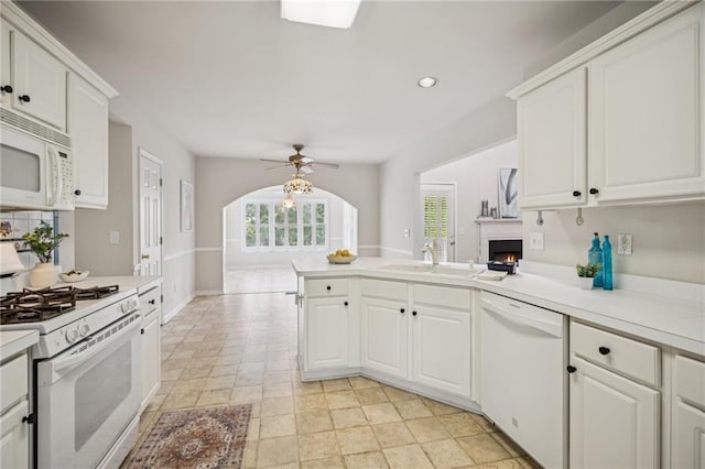 130 White Sands Ct, Suwanee, GA 30024 - kitchen with white appliances, a peninsula, ceiling fan, light countertops, and white cabinetry
