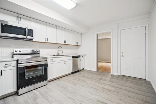 130 White Sands Ct, Suwanee, GA 30024 - kitchen featuring stainless steel appliances, light countertops, light wood-type flooring, and white cabinets