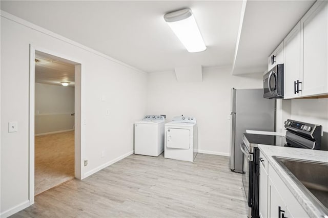 130 White Sands Ct, Suwanee, GA 30024 - kitchen featuring appliances with stainless steel finishes, separate washer and dryer, white cabinetry, light wood finished floors, and ornamental molding