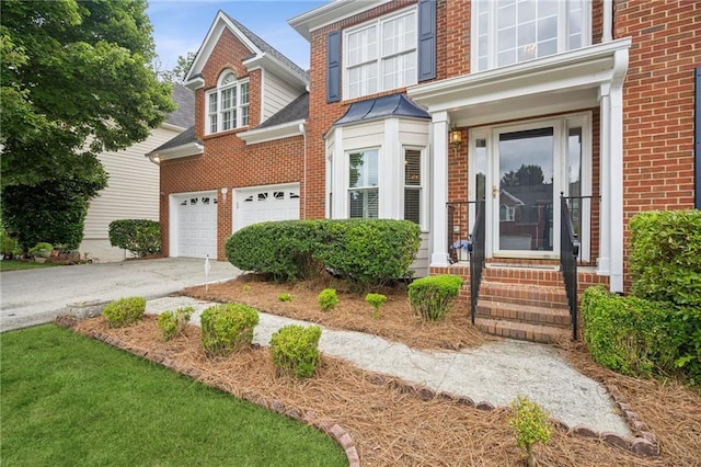 130 White Sands Ct, Suwanee, GA 30024 - view of front of property featuring brick siding, driveway, an attached garage, and entry steps