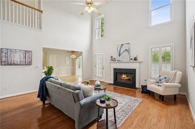130 White Sands Ct, Suwanee, GA 30024 - living room featuring ceiling fan, a high ceiling, healthy amount of natural light, and wood finished floors