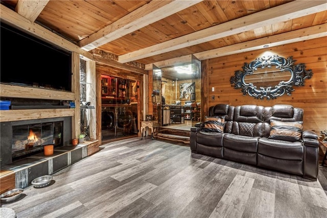 living area featuring wood ceiling, wooden walls, beam ceiling, and wood finished floors