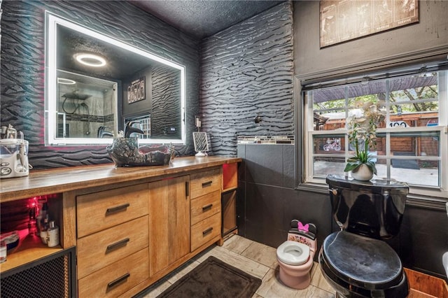 bathroom featuring vanity and a textured ceiling