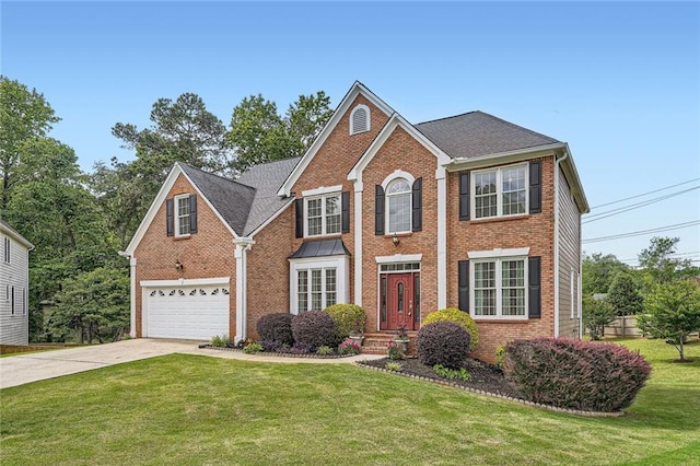 colonial-style house featuring driveway, brick siding, and a garage