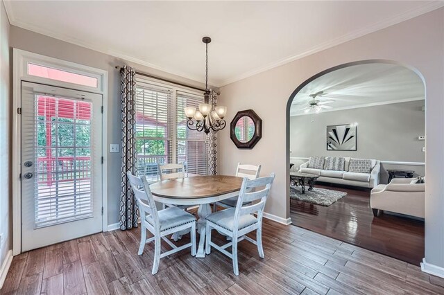 living room with baseboards, wood finished floors, and crown molding