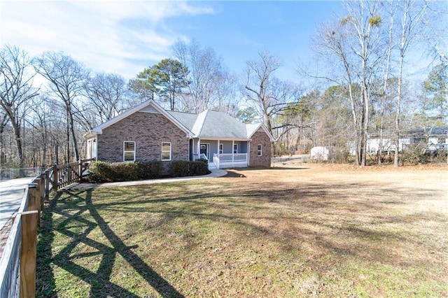 view of front facade with covered porch and a front lawn