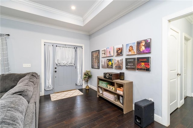 entryway with dark hardwood / wood-style flooring, a tray ceiling, and ornamental molding