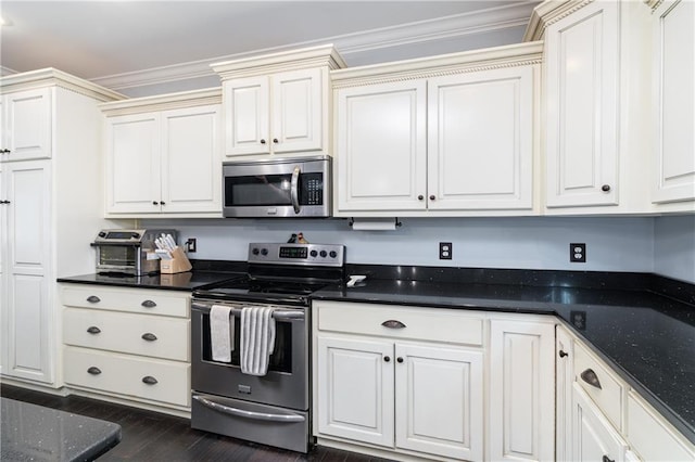 kitchen with dark wood-type flooring, ornamental molding, stainless steel appliances, and dark stone countertops