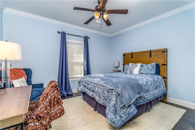 bedroom with ceiling fan, ornamental molding, and wood-type flooring