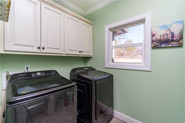 laundry area featuring crown molding, cabinets, and washer and clothes dryer