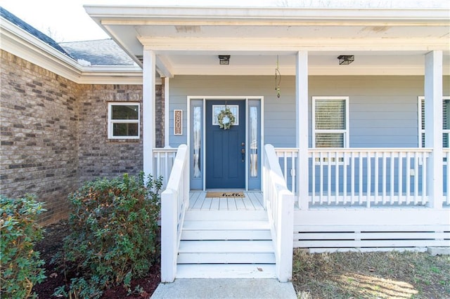 view of exterior entry with covered porch