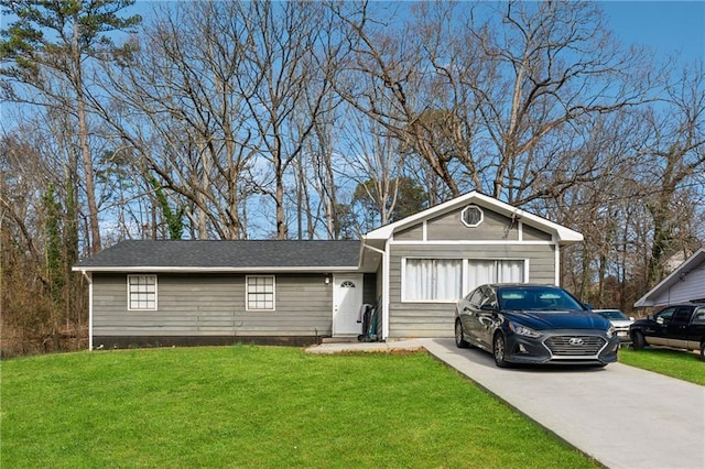 ranch-style home featuring a garage, concrete driveway, and a front yard