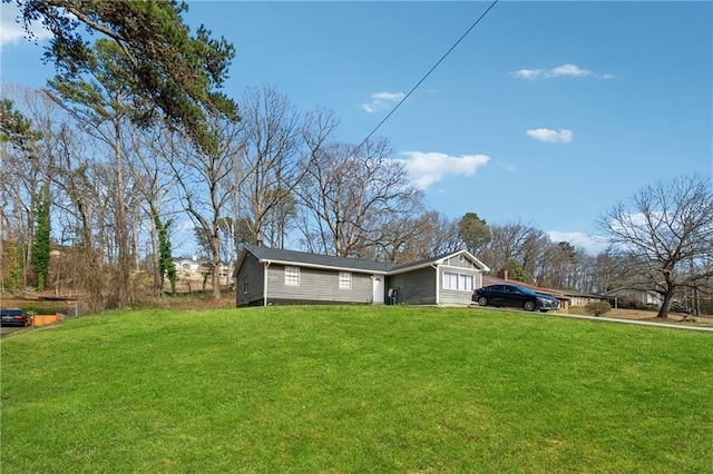 view of side of home featuring a yard