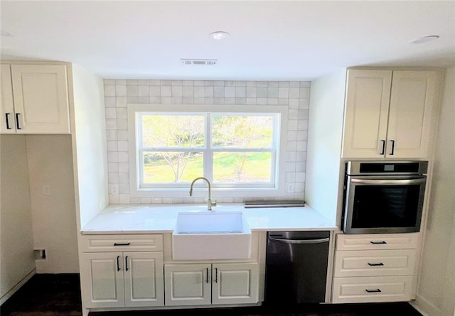 kitchen with sink, oven, and black dishwasher