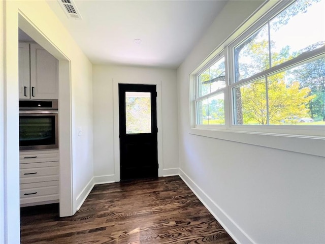 doorway with dark wood-type flooring