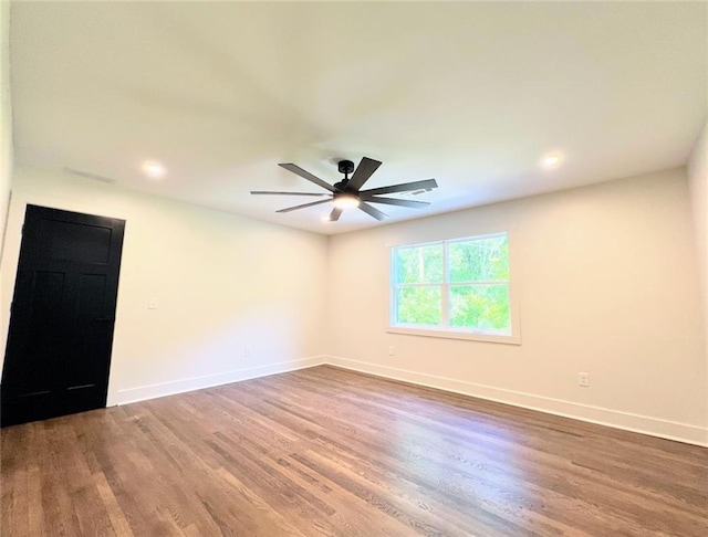 spare room with wood-type flooring and ceiling fan