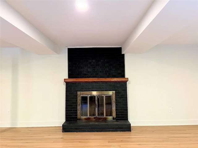 room details with hardwood / wood-style floors and a brick fireplace