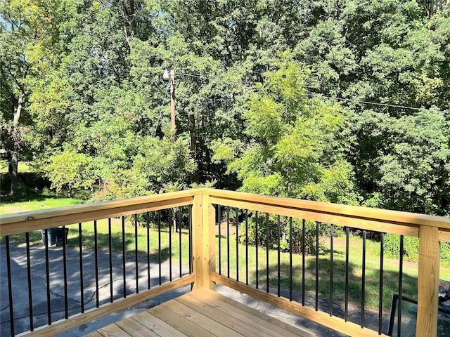 wooden deck with a lawn