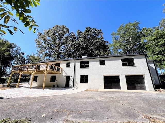 view of front facade with a garage and a deck