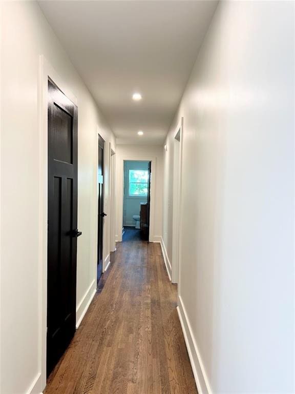 corridor featuring dark hardwood / wood-style flooring