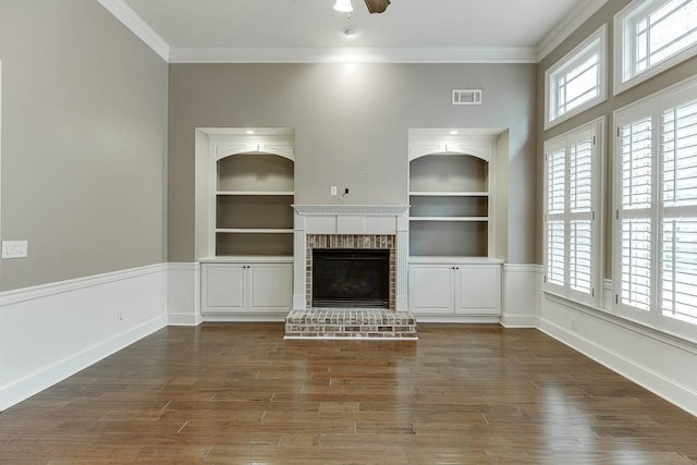 unfurnished living room featuring a wealth of natural light, visible vents, and built in shelves