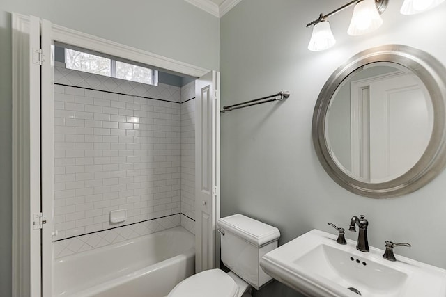 full bathroom featuring toilet, crown molding, bathtub / shower combination, and a sink