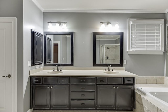 full bathroom with double vanity, ornamental molding, a relaxing tiled tub, and a sink