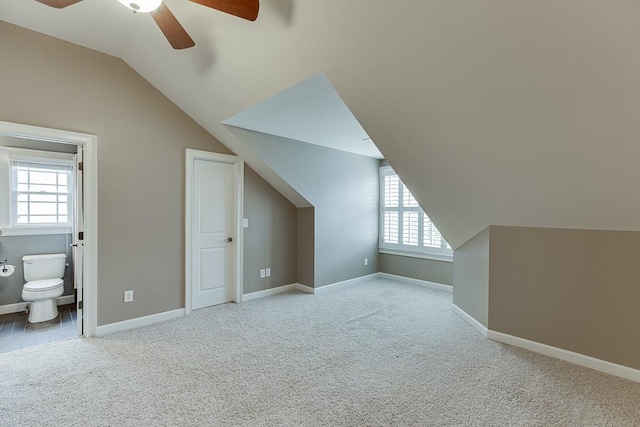 bonus room featuring baseboards, lofted ceiling, ceiling fan, and carpet floors