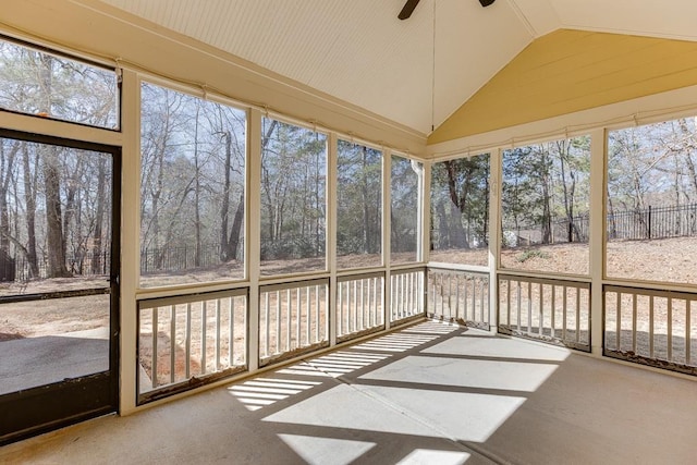 unfurnished sunroom featuring a ceiling fan and vaulted ceiling