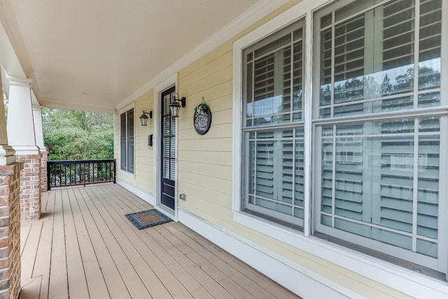 wooden terrace featuring covered porch