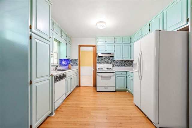 2117 Chestnut Hill Cir, Decatur, GA 30032 - kitchen featuring white appliances, light wood-style flooring, tasteful backsplash, under cabinet range hood, and light countertops