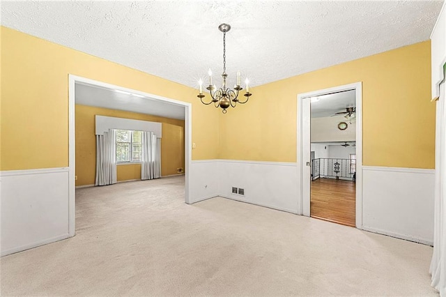2117 Chestnut Hill Cir, Decatur, GA 30032 - spare room with a chandelier, a wainscoted wall, carpet, and a textured ceiling