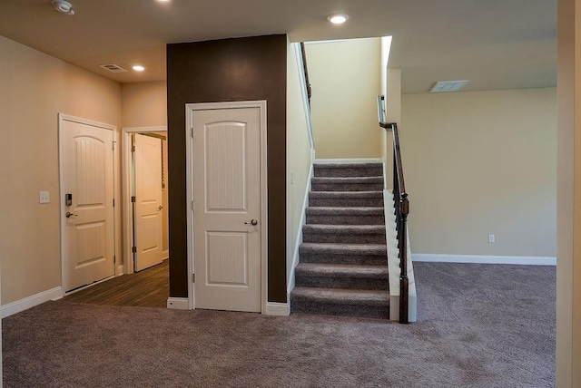 staircase with carpet floors, recessed lighting, and visible vents