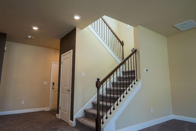 stairs featuring baseboards, visible vents, and carpet flooring