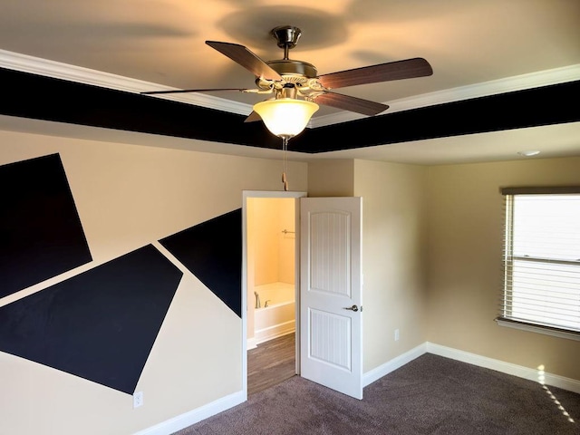 unfurnished room featuring carpet floors, crown molding, baseboards, and a ceiling fan