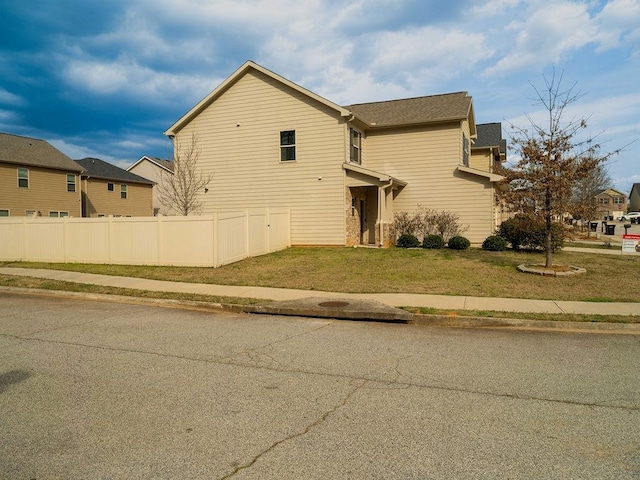 view of front of house featuring a front yard and fence