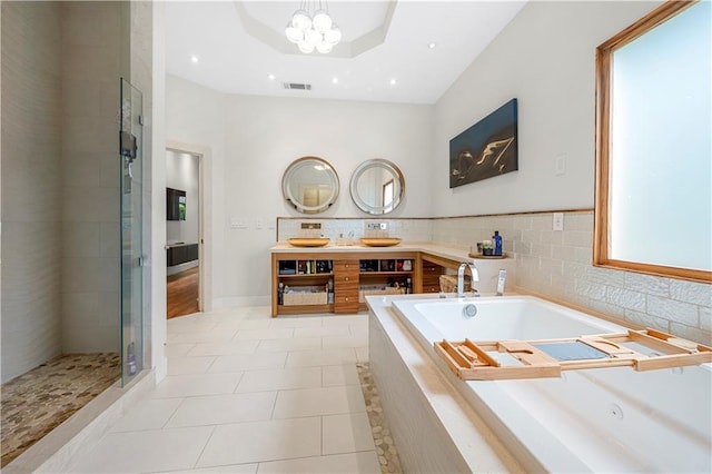 full bath with a tub with jets, tile patterned flooring, a shower stall, a chandelier, and double vanity