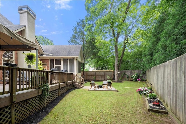 view of yard with a deck and a sunroom