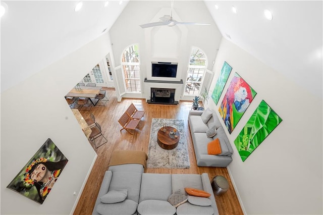 living room with high vaulted ceiling, wood finished floors, a ceiling fan, recessed lighting, and baseboards