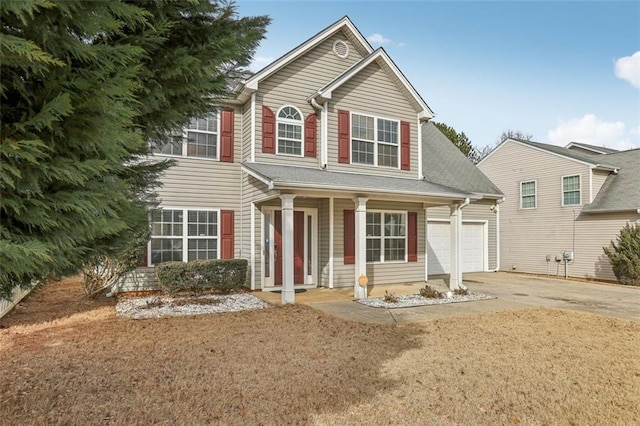 view of front of house featuring a garage, a porch, and a front lawn