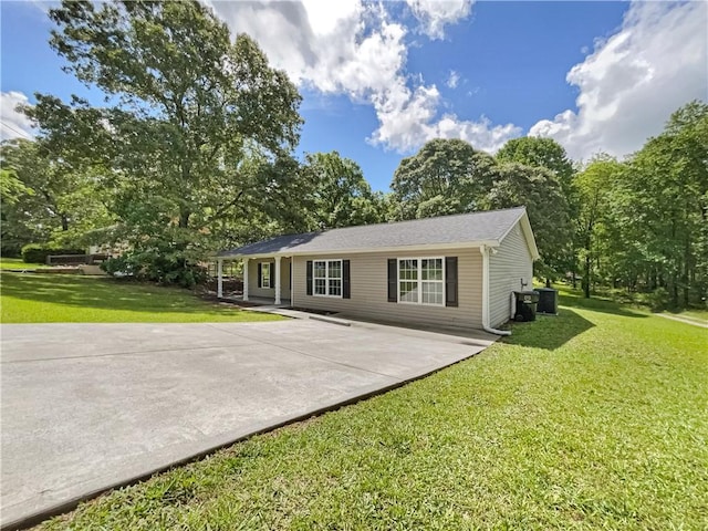 89 Elsberry Rd, Dallas, GA 30157 - back of property featuring a lawn, a patio area, central AC unit, concrete driveway, and view of wooded area