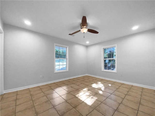 tiled empty room with ceiling fan