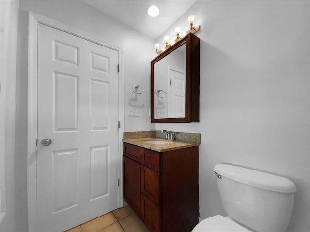 bathroom featuring vanity, tile patterned floors, and toilet